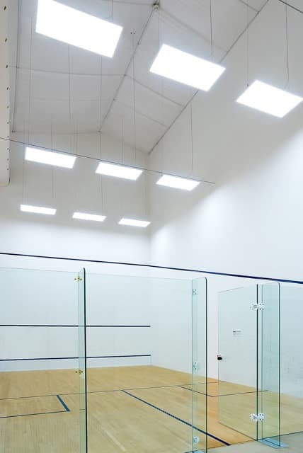 Indoor squash court with bright overhead lighting