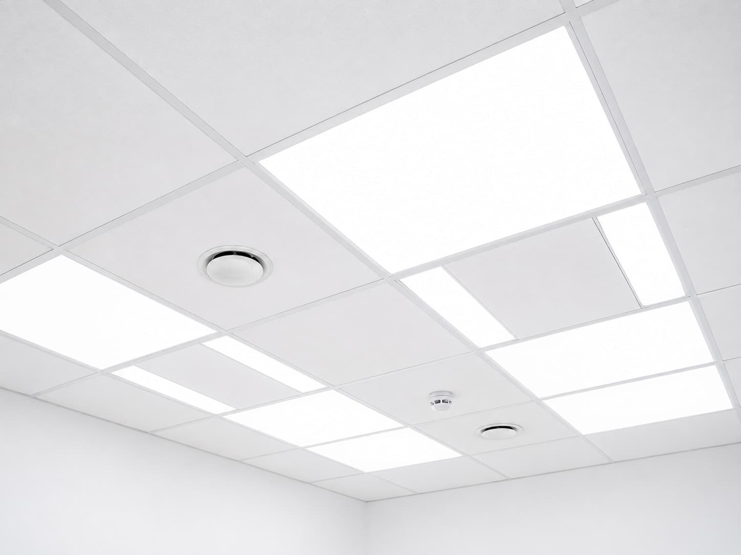 Illuminated LED ceiling panels in a suspended office ceiling grid